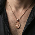 Load image into Gallery viewer, Rose gold plated phoenix medallion necklace worn on neck, lifestyle wear shot, warm plating tone and sculpted depth