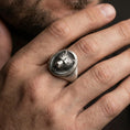 Load image into Gallery viewer, Oxidized bear head signet ring worn on finger, lifestyle close-up, oval face centered with rugged masculine styling