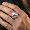 Load image into Gallery viewer, Polished silver raccoon signet ring worn on finger, clean lifestyle framing, reflective finish and crisp relief definition