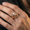 Load image into Gallery viewer, Rose gold plated raccoon signet ring worn on finger, lifestyle wear shot, warm plating tone and sculpted depth