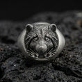 Load image into Gallery viewer, Oxidized sterling silver raccoon head signet ring on volcanic rock, detailed fur texture and paws relief, macro studio shot