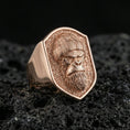Load image into Gallery viewer, Rose gold plated gorilla warrior signet ring on volcanic rock, textured lava stone background, detailed helmet and fur engraving