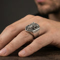 Load image into Gallery viewer, Oxidized ram head signet ring worn on finger, lifestyle close-up, masculine statement ring with raised horn design