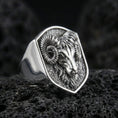 Load image into Gallery viewer, Polished silver ram head signet ring on volcanic rock, sharp horn detailing and sculpted fur lines, studio close-up