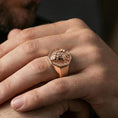 Load image into Gallery viewer, Rose gold plated lioness signet ring worn on finger, lifestyle wear shot, lioness head signet ring highlighting raised relief and bezel edges
