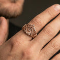Load image into Gallery viewer, Rose gold plated Masonic signet ring on the finger, close-up lifestyle image focusing on the “G” emblem and ornate scrollwork