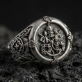 Load image into Gallery viewer, Oxidized sterling silver Saint Peter signet ring with Keys of Heaven and papal tiara relief, macro on black volcanic rock