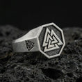 Load image into Gallery viewer, Sterling silver Valknut signet ring with an oxidized finish, octagon face featuring a Norse triple-triangle symbol, macro on black volcanic rock