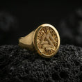 Load image into Gallery viewer, Sterling silver Valknut signet ring with a gold plated finish, round signet face showing the Valknut Norse symbol with textured background, macro on volcanic rock