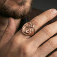 Load image into Gallery viewer, Rose gold plated finish anchor and snake signet ring on the finger, macro lifestyle shot focusing on the raised anchor and serpent wrap design