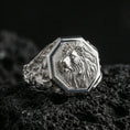 Load image into Gallery viewer, Polished silver lion signet ring on volcanic rock, octagonal signet face with detailed lion mane engraving and crisp beveled frame, premium close-up