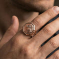 Load image into Gallery viewer, Rose gold plated octagon lion signet ring worn on finger, lifestyle wear shot showcasing octagonal lion emblem and carved scrollwork shoulders