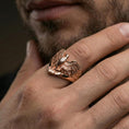 Load image into Gallery viewer, 925 sterling silver eagle ring worn on a finger, rose gold plated finish with smooth luster and bold eagle wing silhouette