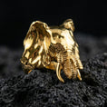 Load image into Gallery viewer, Gold plated elephant ring on porous volcanic stone, luxury studio lighting emphasizing sculpted face texture