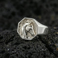 Load image into Gallery viewer, Polished silver horse signet ring on volcanic rock surface, close-up highlighting engraved mane details and clean geometric bezel