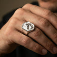 Load image into Gallery viewer, Polished silver wolf ring on finger, natural hand pose highlighting the detailed fur relief and strong masculine silhouette