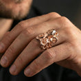 Load image into Gallery viewer, Rose gold plated octopus ring on finger, close-up lifestyle photo showcasing the octopus head, curled tentacles, and premium finish look