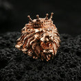 Load image into Gallery viewer, Rose gold plated lion head ring on volcanic rock, sharp macro product photo showcasing the king crown design and detailed roaring lion expression