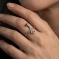 Load image into Gallery viewer, Oxidized cobra snake ring worn on finger, lifestyle close-up focusing on the raised hood, coiled body, and detailed scale texture