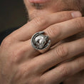 Load image into Gallery viewer, Oxidized horseshoe horse ring worn on finger, lifestyle close-up focusing on the bridled horse head and open horseshoe frame design