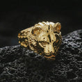 Load image into Gallery viewer, Gold plated lioness head ring on black volcanic stone, close-up highlighting the sculpted face and relief depth