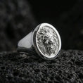 Load image into Gallery viewer, Polished silver lion signet ring on porous volcanic stone, close-up focusing on the crisp mane engraving and smooth round bezel edge