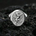 Load image into Gallery viewer, Polished silver royal lion signet ring on porous volcanic stone, close-up focusing on the crisp heraldic engraving and smooth round bezel edge