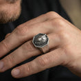 Load image into Gallery viewer, Oxidized sterling silver octagon wolf ring worn on a finger, angled view showing the geometric face and profile