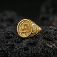 Load image into Gallery viewer, Gold plated yin yang koi signet ring on black volcanic rock, close-up highlighting the relief details