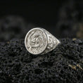 Load image into Gallery viewer, Polished silver koi fish ring on textured volcanic stone, macro focus on the engraved yin yang koi design