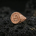 Load image into Gallery viewer, Rose gold plated koi fish harmony ring on porous volcanic rock with soft directional lighting
