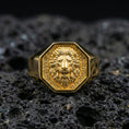 Load image into Gallery viewer, Gold plated octagon lion signet ring on black volcanic rock with crisp highlights and deep shadows