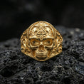 Load image into Gallery viewer, Sterling silver masonic skull ring with a gold plated finish, gothic freemason skull motif with engraved filigree shoulders, macro on volcanic rock