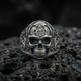 Load image into Gallery viewer, Sterling silver masonic skull ring with an oxidized finish, engraved gothic skull design with all-seeing eye triangle detail, macro on black volcanic rock