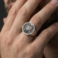 Load image into Gallery viewer, Sterling silver Armenian coat of arms signet ring worn on a finger, close-up lifestyle shot highlighting the oxidized heraldic crest and octagonal signet face