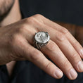 Load image into Gallery viewer, Sterling silver mystical signet ring on a finger, macro lifestyle image emphasizing the polished silver finish and engraved eye above pyramid design