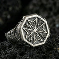 Load image into Gallery viewer, Sterling silver Maltese cross signet ring with an oxidized finish, octagonal face featuring a Crusader-style cross and ornamental relief details, macro on black volcanic rock