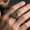Load image into Gallery viewer, Sterling silver Maltese cross signet ring worn on a finger, close-up lifestyle shot highlighting the oxidized octagonal face and Crusader-inspired cross motif