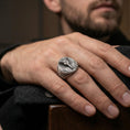 Load image into Gallery viewer, Sterling silver Egyptian pharaoh signet ring worn on a finger, close-up lifestyle shot highlighting the oxidized oval face and royal portrait engraving