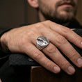 Load image into Gallery viewer, Sterling silver ancient Egypt statement ring on a finger, macro lifestyle image emphasizing the polished silver pharaoh relief and carved side details