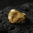 Load image into Gallery viewer, Sterling silver Egyptian king ring with a gold plated finish, oval signet design showing a pharaoh bust with headdress detail and ornate side engravings, macro product shot on volcanic rock