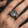 Load image into Gallery viewer, Sterling silver Greek warrior signet ring worn on a finger, close-up lifestyle shot highlighting the oxidized round face and Spartan soldier engraving