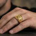 Load image into Gallery viewer, Sterling silver lion crest signet ring worn on a finger, close-up lifestyle photo showcasing the gold plated finish and raised cross-and-lion emblem
