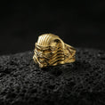 Load image into Gallery viewer, Sterling silver pharaoh mummy ring with a gold plated finish, detailed undead mask design and engraved side symbols, macro product shot on volcanic rock
