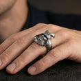 Load image into Gallery viewer, Sterling silver samurai mask ring worn on a finger, close-up lifestyle shot highlighting the oxidized finish and detailed kabuto helmet with fierce warrior face