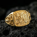 Load image into Gallery viewer, Sterling silver medieval knight ring with a gold plated finish, Templar-inspired shield face featuring crown, swords and cross symbolism, macro product shot on volcanic rock