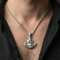 Load image into Gallery viewer, Sterling silver Norse battle axe necklace on the neck, macro lifestyle image showing the polished silver finish and engraved Vegvisir emblem