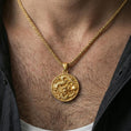Load image into Gallery viewer, Sterling silver dragon coin pendant worn on the neck, close-up lifestyle photo featuring the gold plated finish and high-relief dragon motif