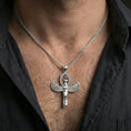 Load image into Gallery viewer, Sterling silver winged Isis pendant necklace on the neck, macro lifestyle image showing the polished silver finish and Egyptian goddess relief
