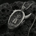 Load image into Gallery viewer, Sterling silver oni mask pendant with an oxidized finish, Japanese demon face with horns and fangs in high relief, close-up on black volcanic rock